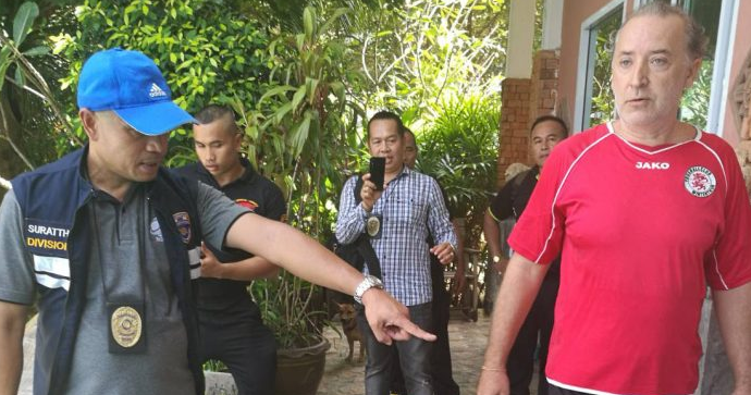 A Surat Thani immigration police officer points at Josef Ruzicka, who was arrested Monday on Koh Tao.